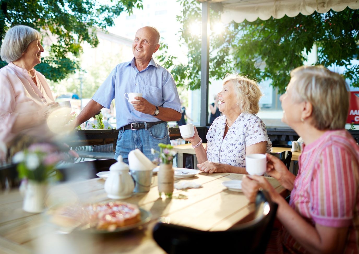 Residents enjoying coffee outdoors in a social setting
