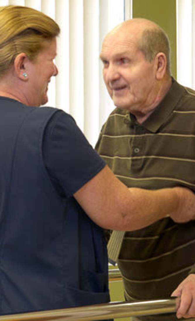 Staff interacting with a resident in an indoor setting