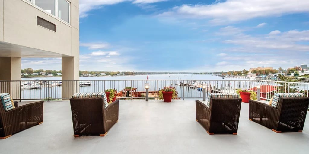 Outdoor seating area overlooking a tranquil lake