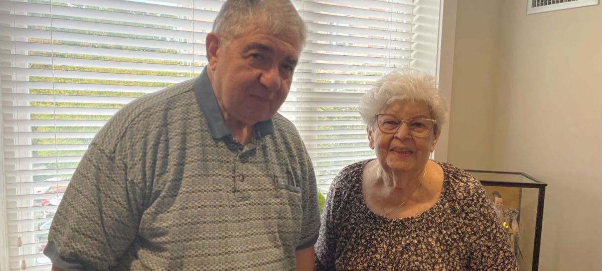 Two residents smiling in a well-lit common area