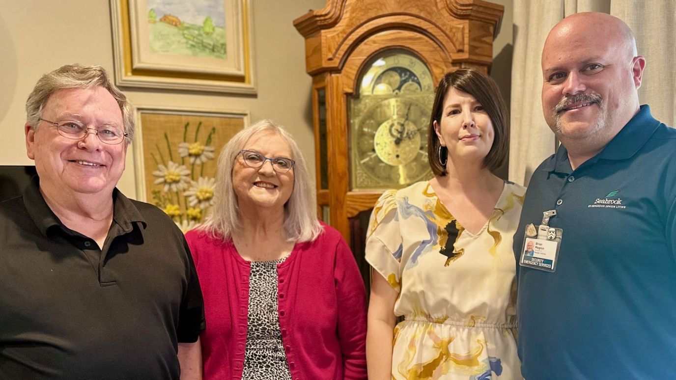 Residents and staff smiling together indoors
