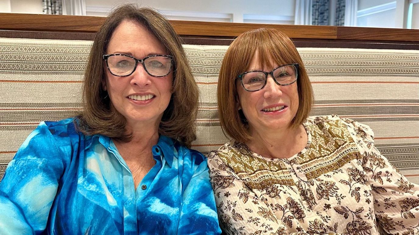 Two residents smiling together in a cozy setting