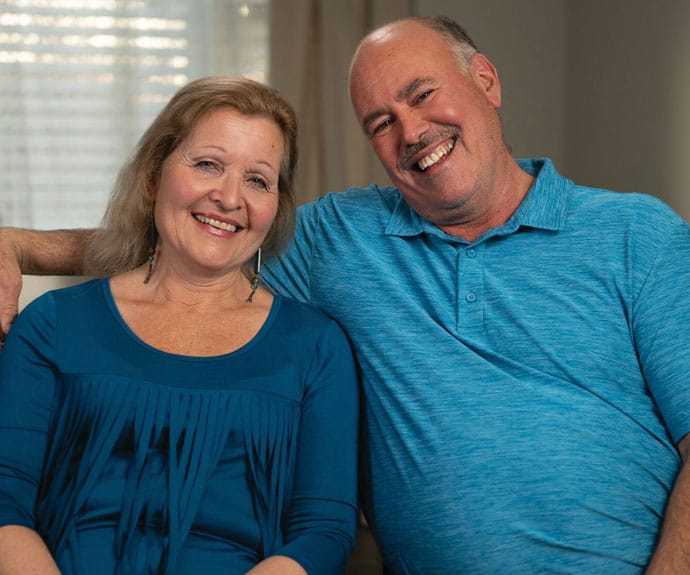 Smiling elderly couple posing together indoors