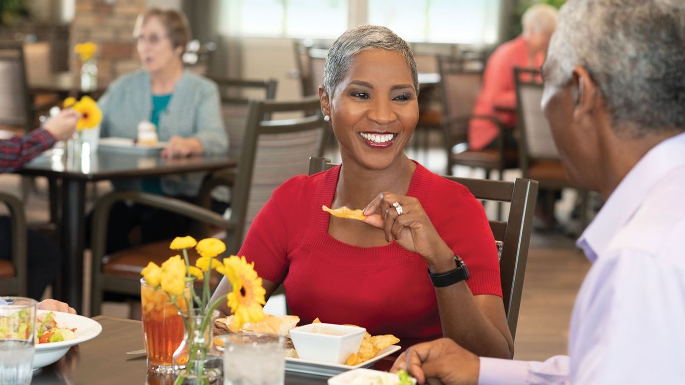 Residents enjoying a meal together in the dining room