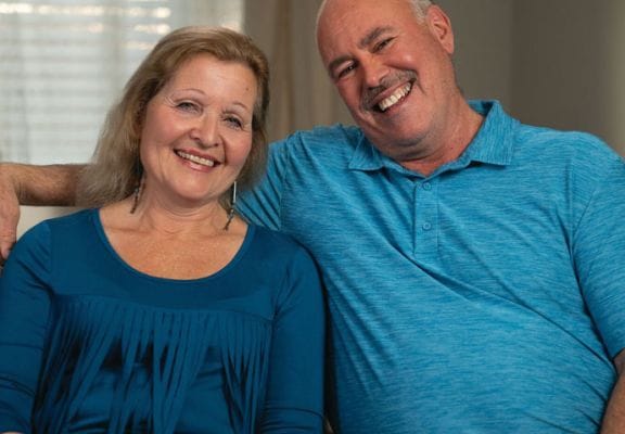 Two smiling residents sitting together