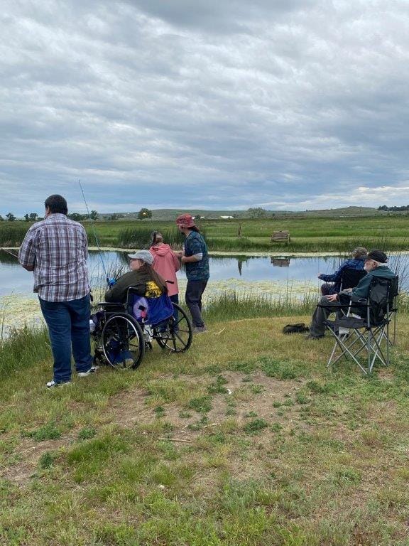 Residents fishing by a tranquil pond