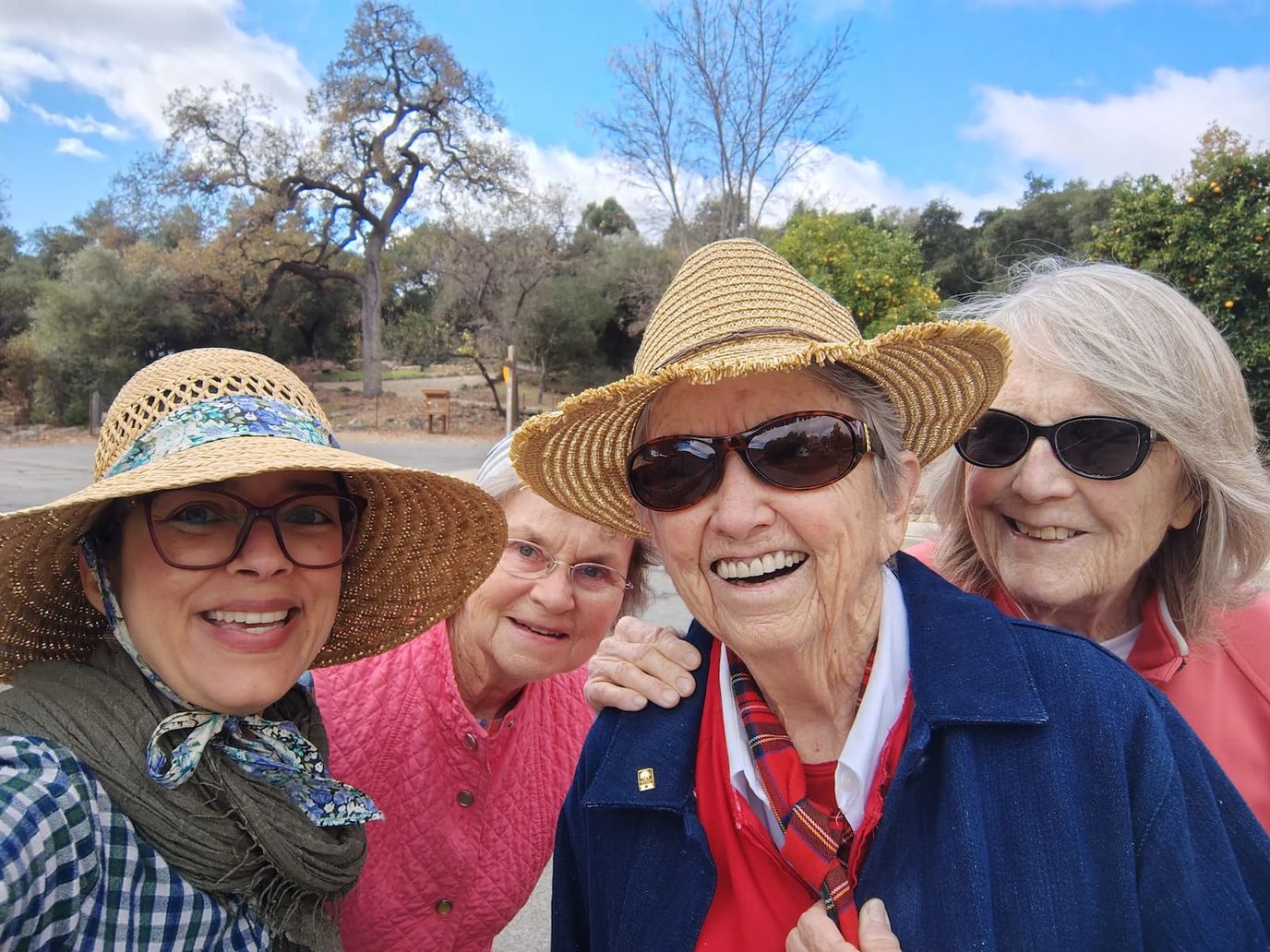 Residents enjoying a sunny day outdoors with smiles
