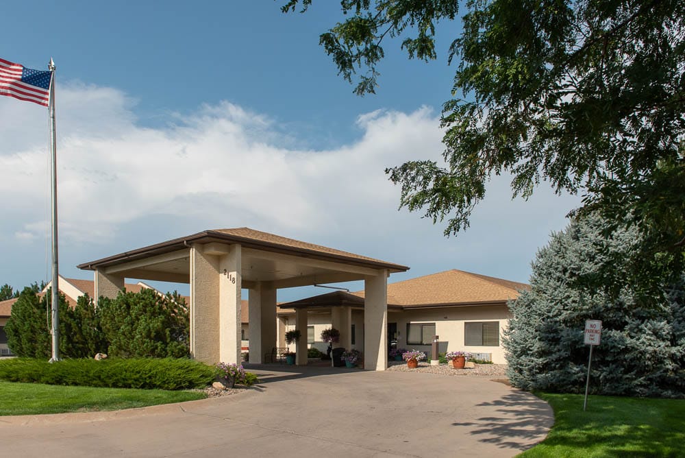 Exterior view of the facility with landscaping and flag