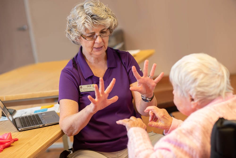 Staff member engaging with a resident during therapy
