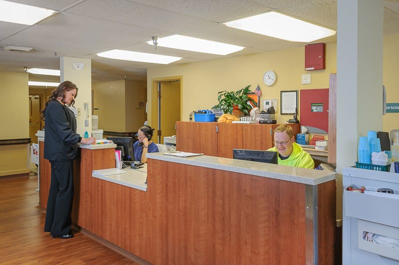 Staff attending to residents at the reception area