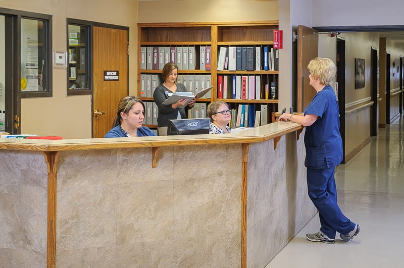 Staff assisting visitors at the reception area