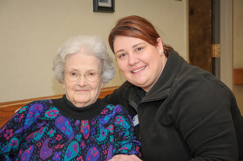 Resident and staff member posing together