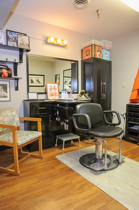 Hair salon area with styling chair and mirror
