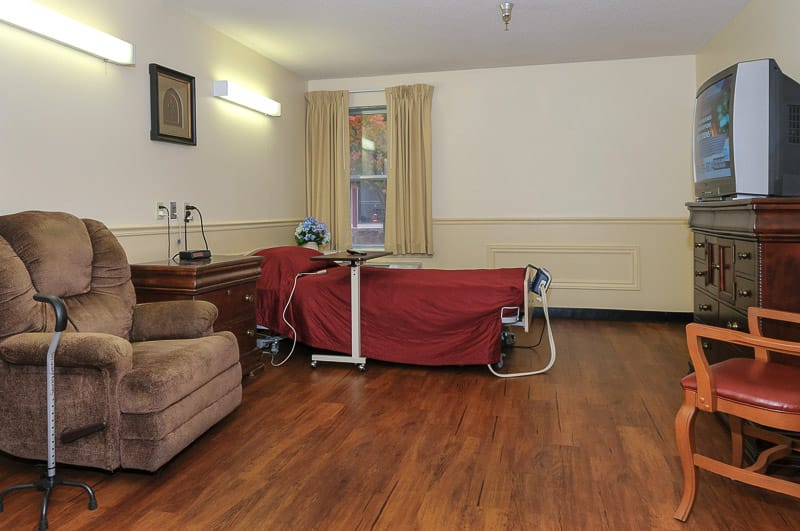 Cozy resident room with furniture and TV