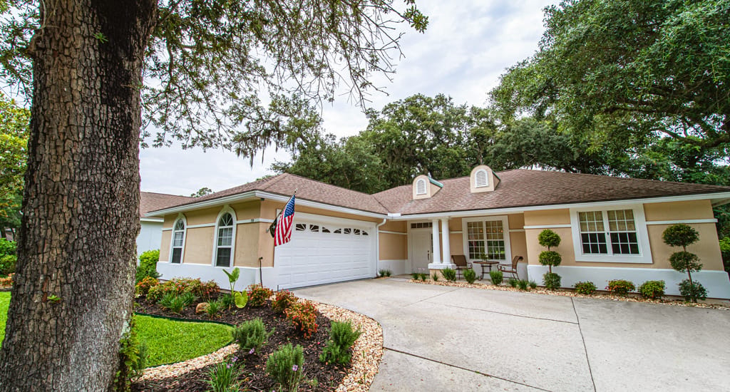Exterior view of a senior living facility with landscaping