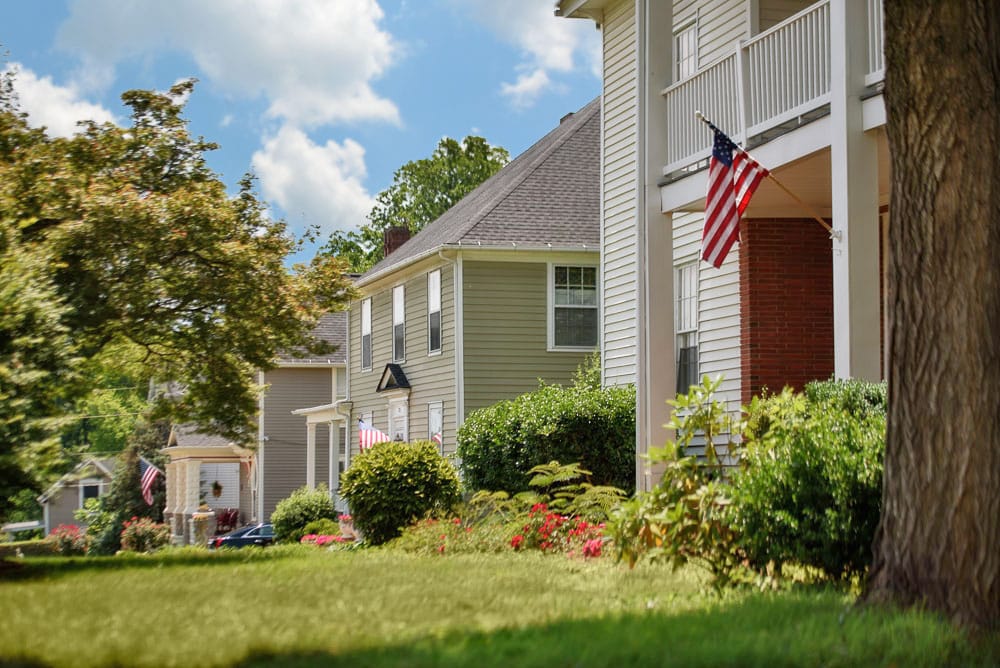 Exterior view of a senior living facility with American flags