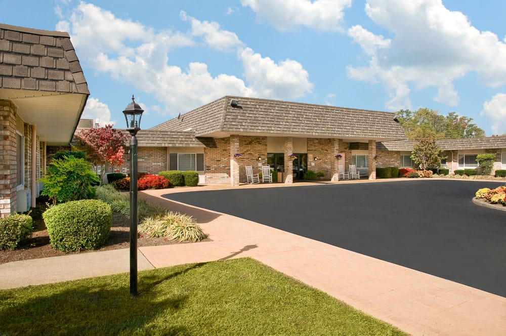 Exterior view of the assisted living facility with landscaped garden