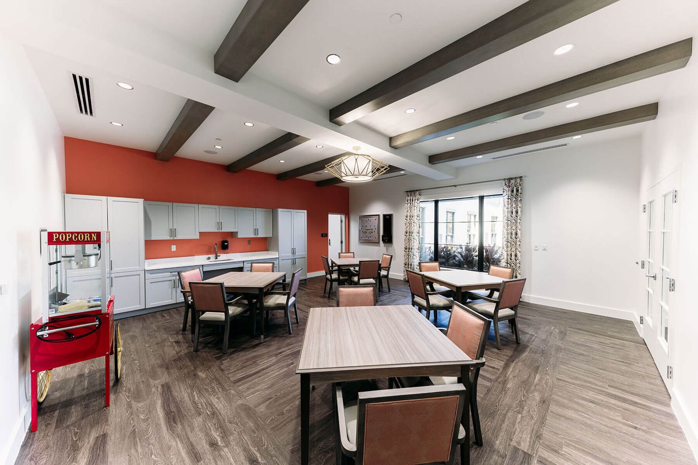 Bright common area with dining tables and chairs