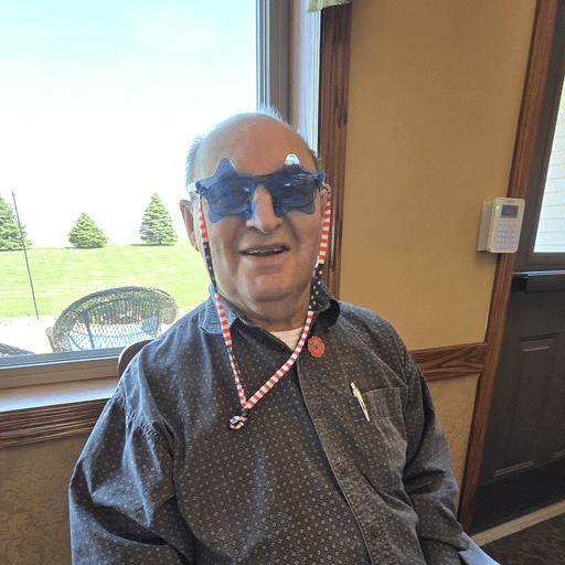 A resident wearing festive star-shaped sunglasses.