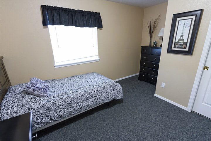 A private room with a bed and furniture