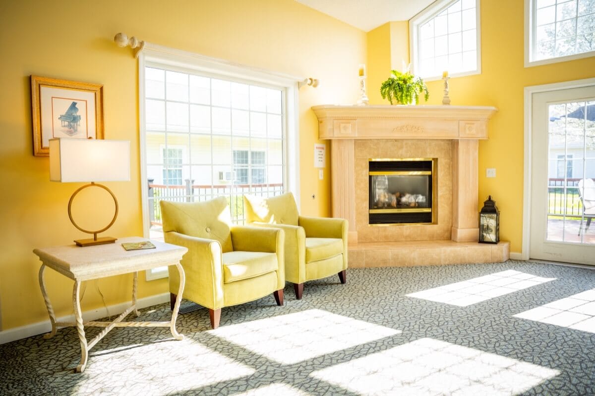 Bright common area with seating and fireplace