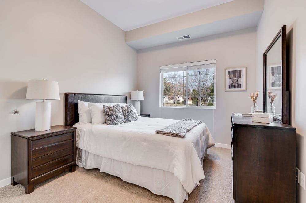 A well-furnished private bedroom in a senior living facility