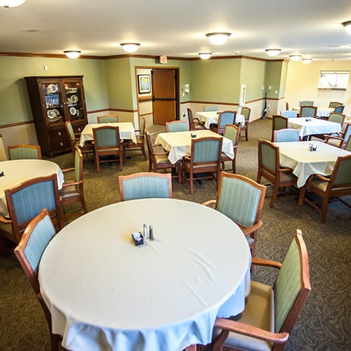 Dining room with tables and chairs arranged for meals