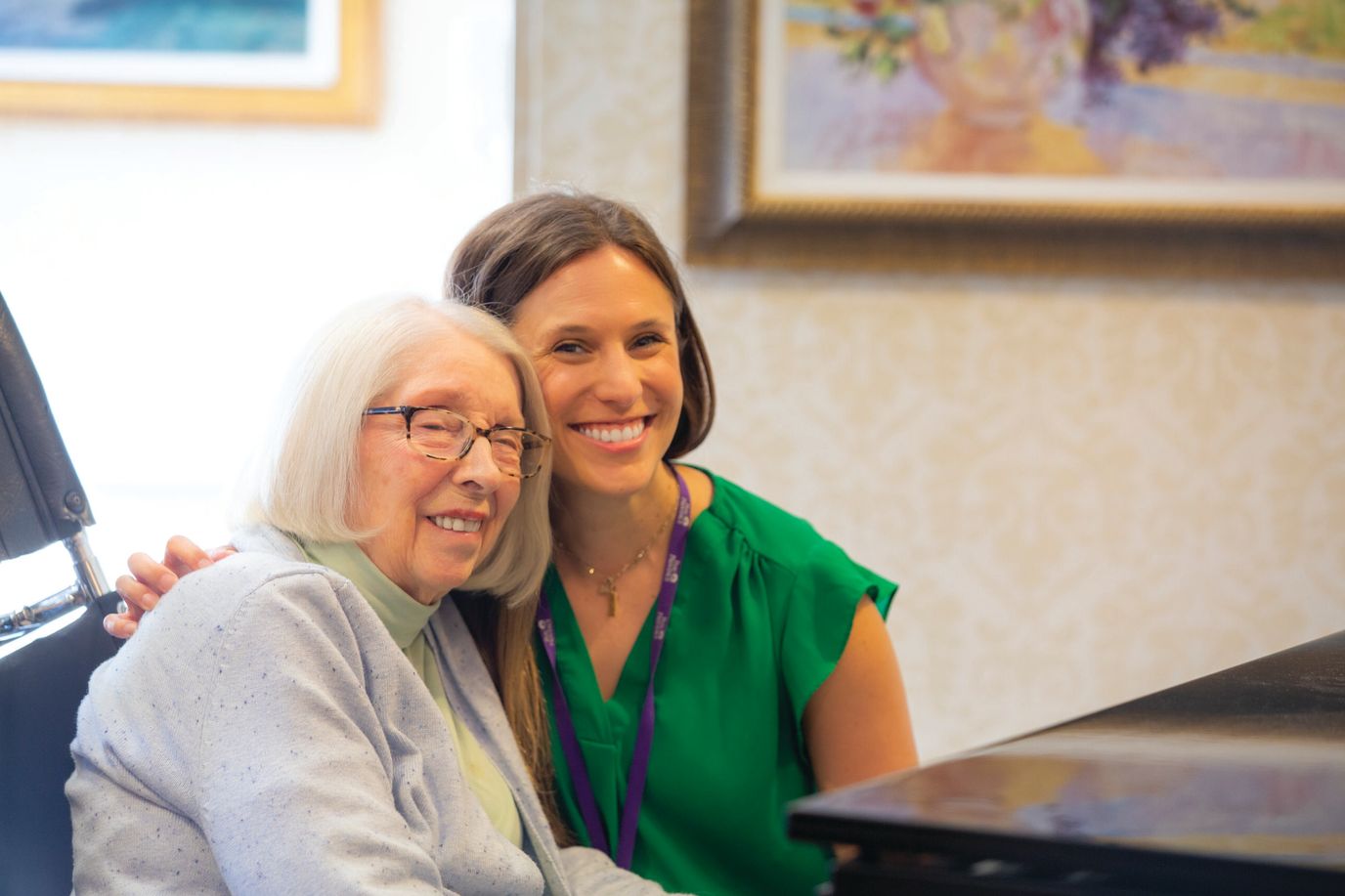A staff member posing happily with a resident
