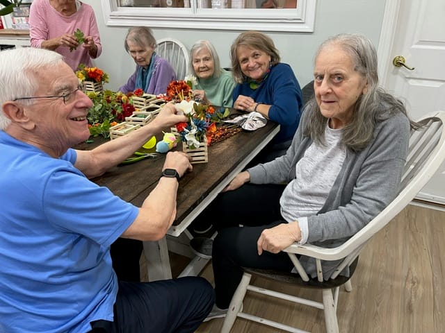Residents participating in a floral arrangement activity
