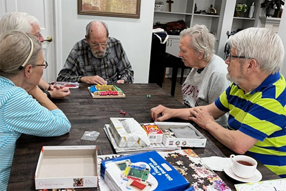 Residents playing a board game together in a common area