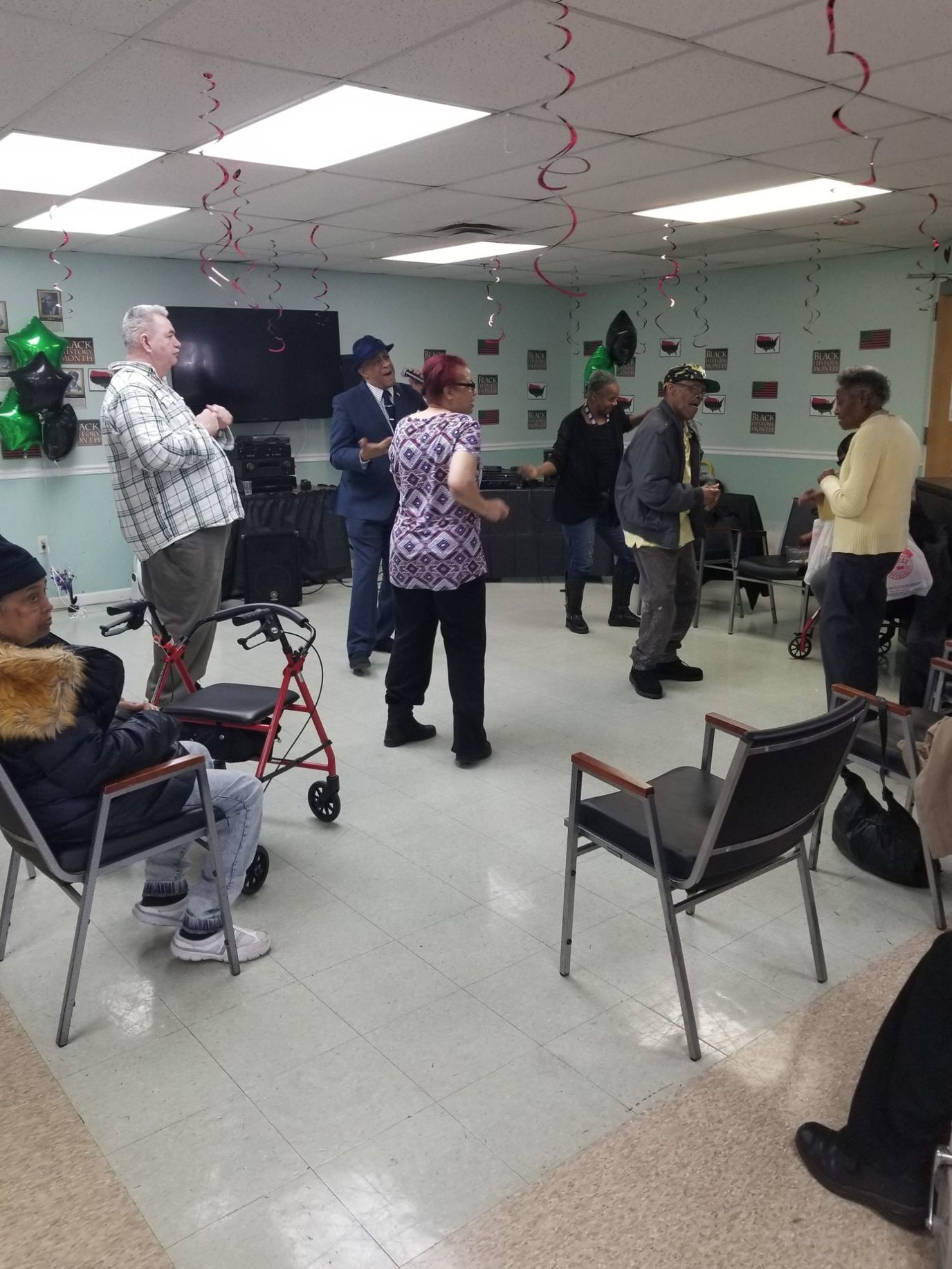 Residents enjoying a celebration in a common area