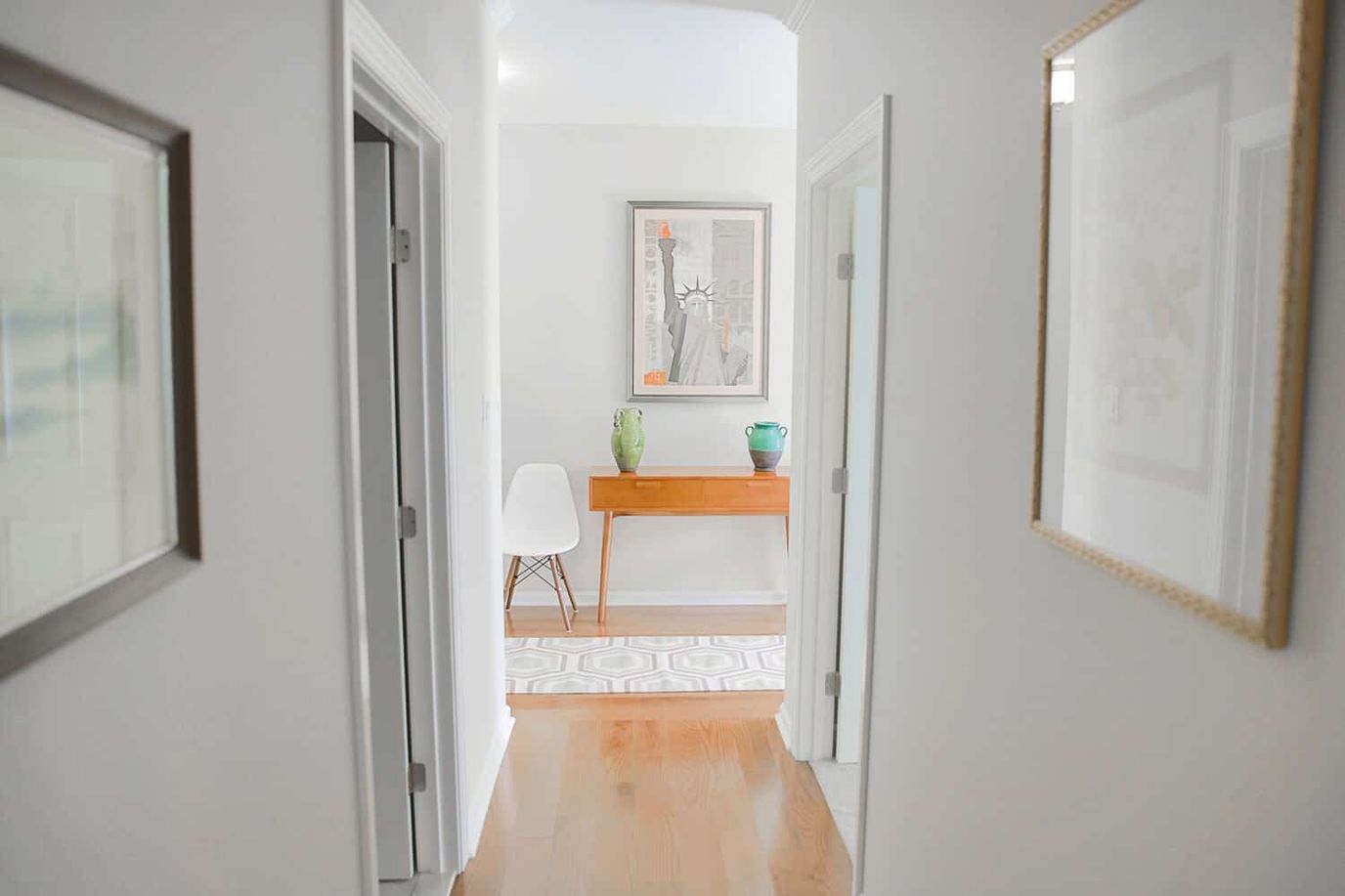 Interior hallway leading to a common area with art