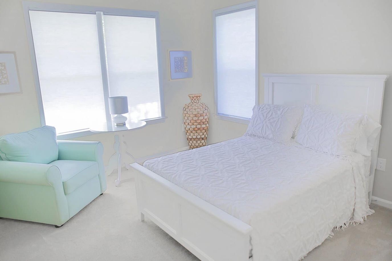 Brightly decorated room with a bed and chair