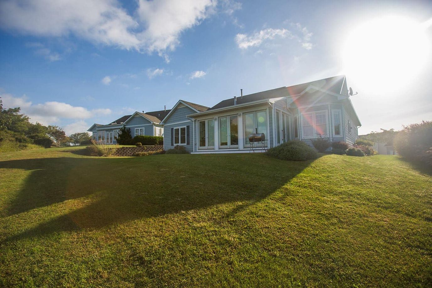 Exterior view of assisted living buildings surrounded by green lawns