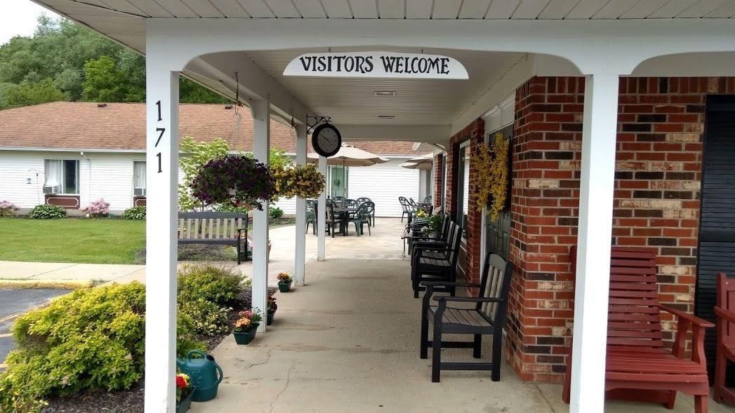 Covered outdoor area with seating and welcome sign