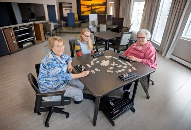 Residents enjoying a game together in a common area