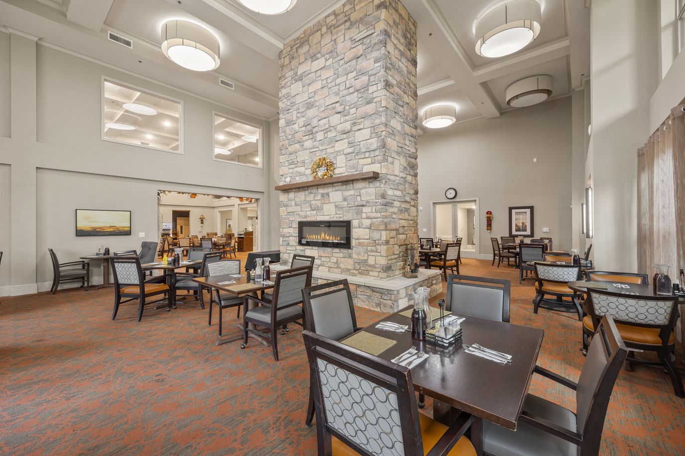 Interior view of a dining room with tables and stone fireplace