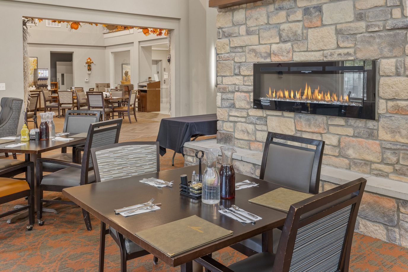 Dining area with a modern fireplace and seating
