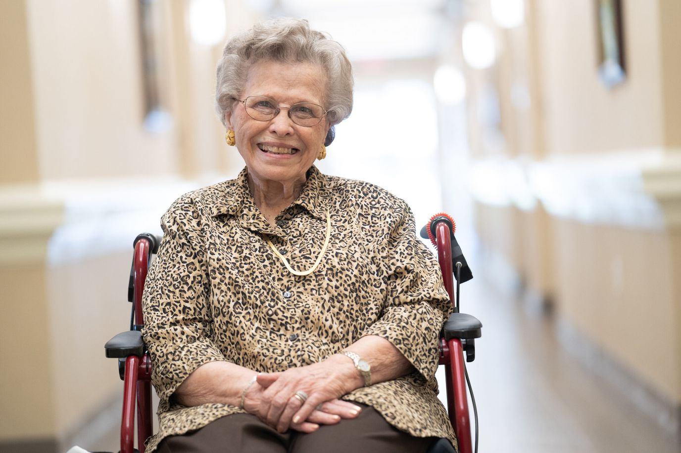 Senior resident smiling in a hallway