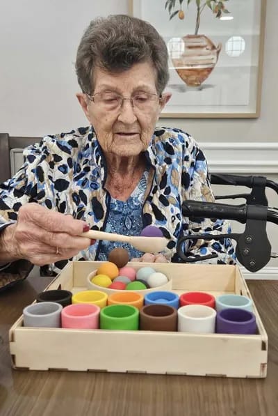 Resident engaging in a creative activity with colorful materials