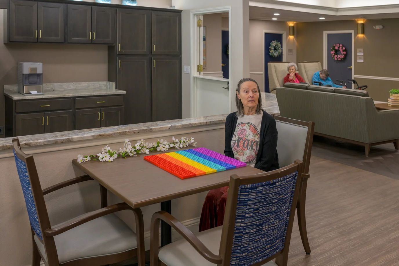 Resident engaged in a colorful activity in a lounge area