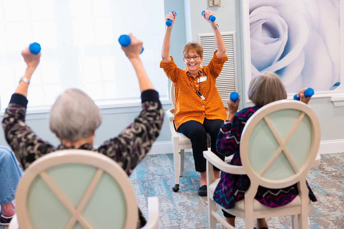 Residents participating in an exercise class with weights