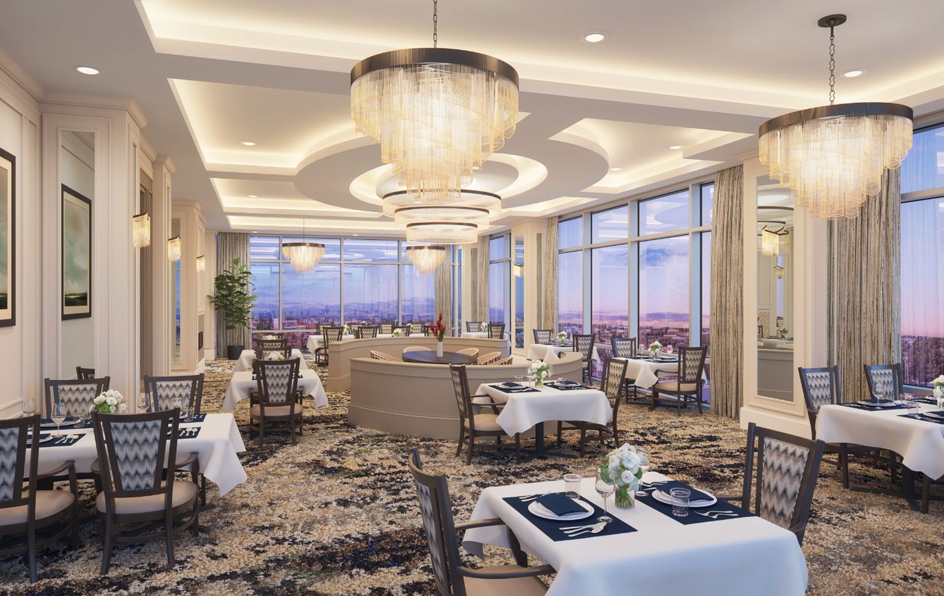 Elegant dining room with chandeliers and large windows