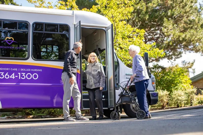 Residents interacting by a facility transport vehicle