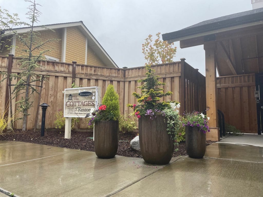 Welcoming outdoor entrance with flower pots at the Cottages of Renton