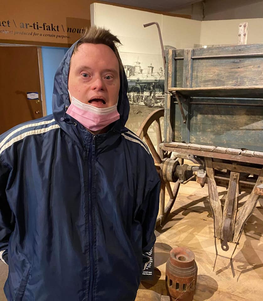 Person in a museum setting with historic cart