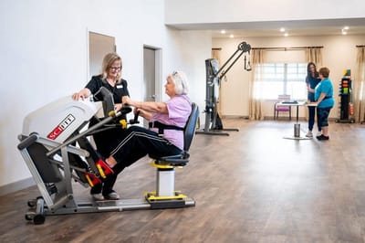 Residents engaging in exercise with staff support