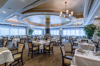 Elegant dining room with tables set for meals