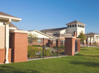 Exterior view of the Avita Assisted Living building and gardens