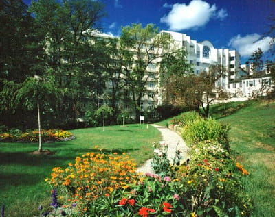Wesley Glen Retirement Community, Nursing Home in Columbus, OH — Scenic view of gardens with the retirement community building in the background